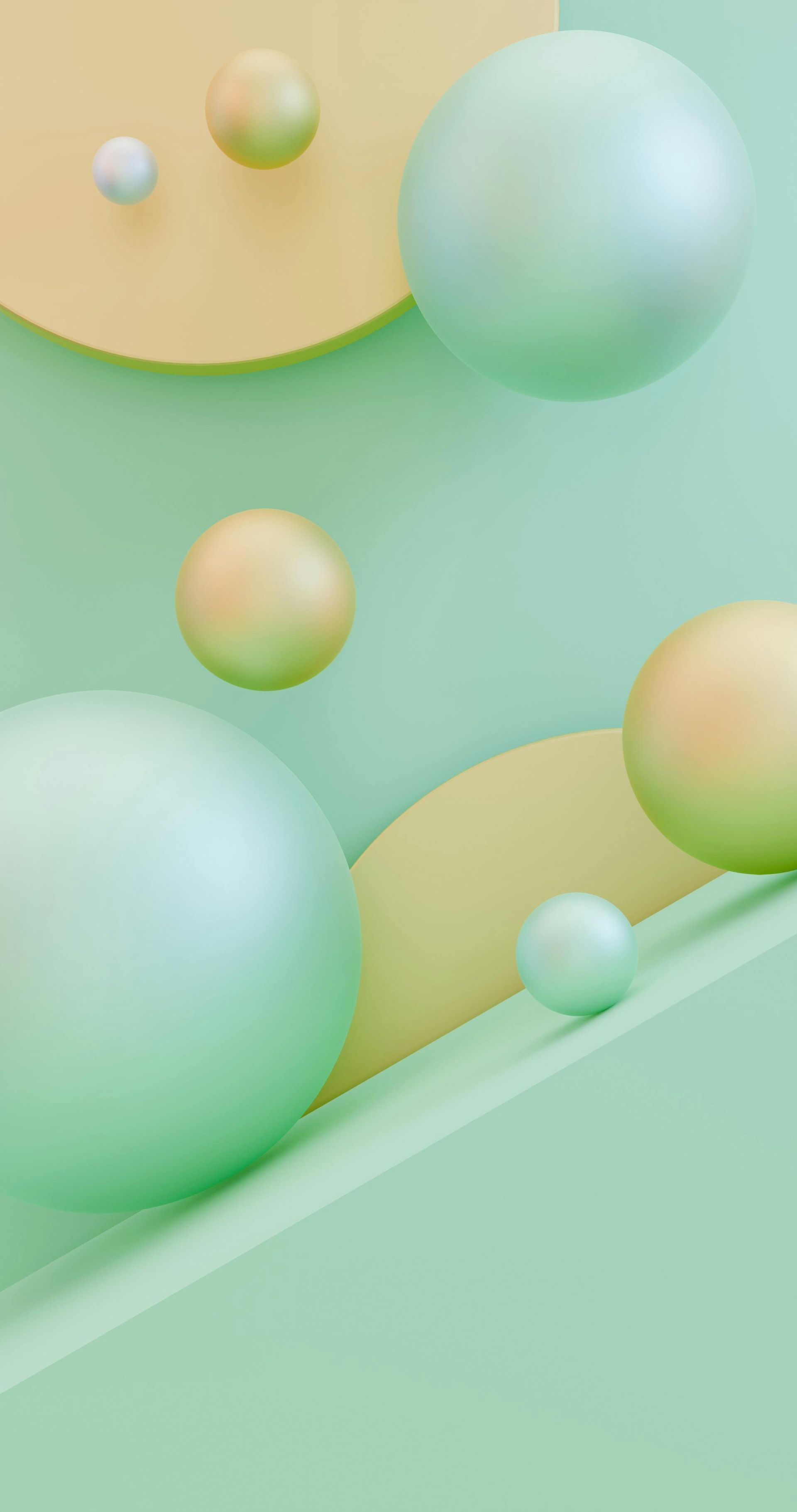 Abstract wallpaper featuring spheres of varying sizes in soft mint green and yellow against a matching geometric background.