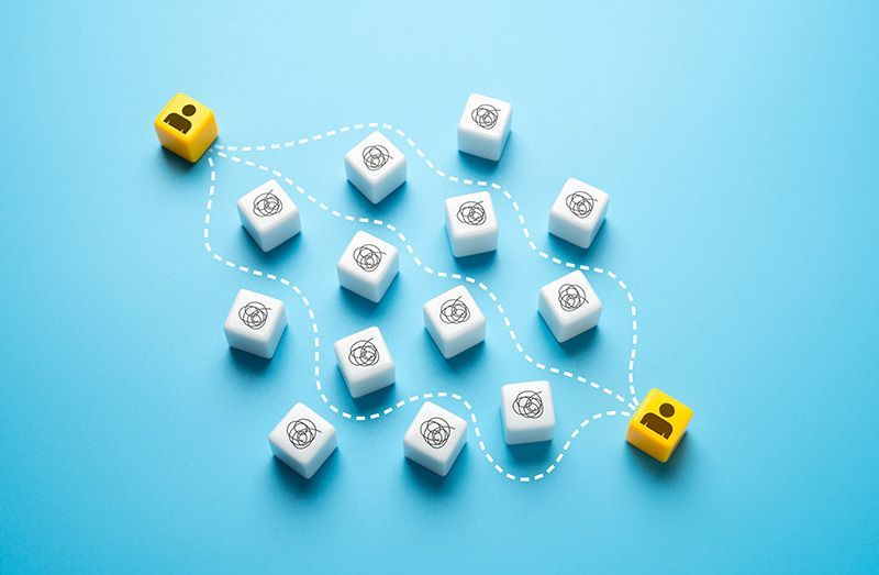 image of 2 cubes with people navigating a maze of other cubes
