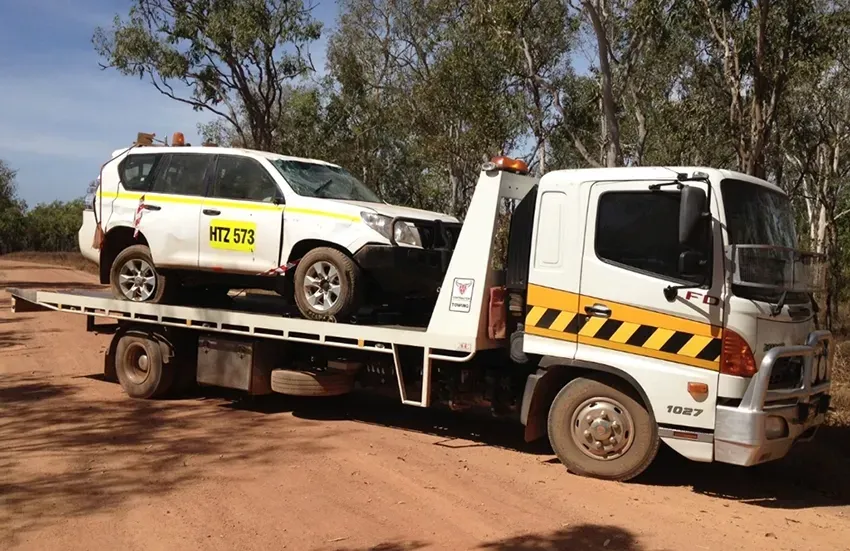 Tow Truck Carrying A Damaged 4WD In the Outback — Prompt Tilt Tray Towing & Recovery in Katherine, NT