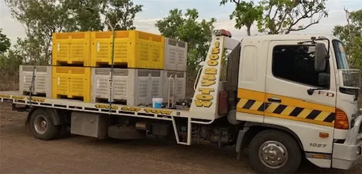 Tow Truck Carrying Yellow and White Crates — Prompt Tilt Tray Towing & Recovery in Humpty Doo, NT