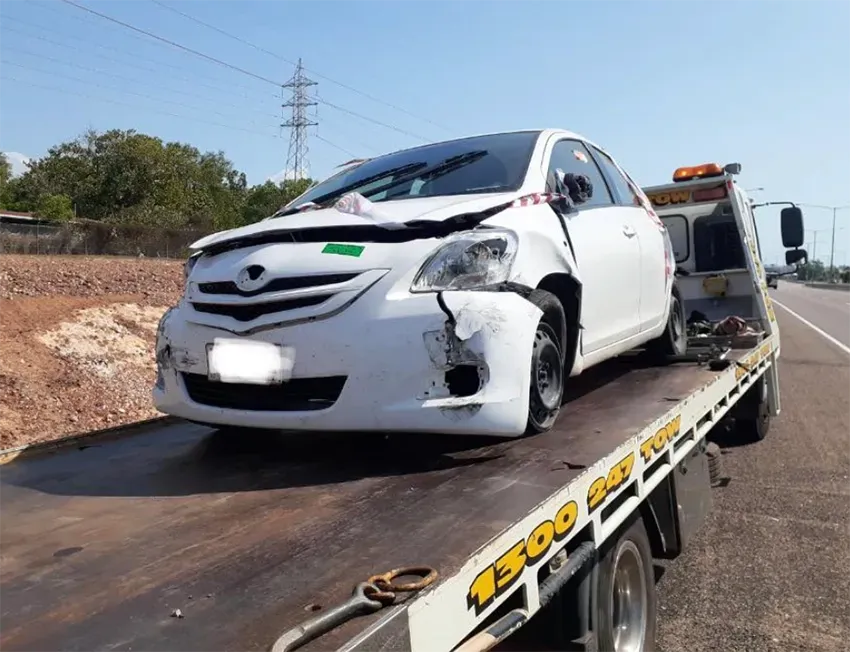 White Car With Front-end Damage Being Towed by a Tow Truck — Prompt Tilt Tray Towing & Recovery in Humpty Doo, NT