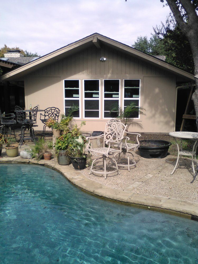 A house with a swimming pool in front of it
