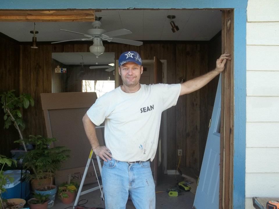 A man wearing a white shirt with the word jean on it