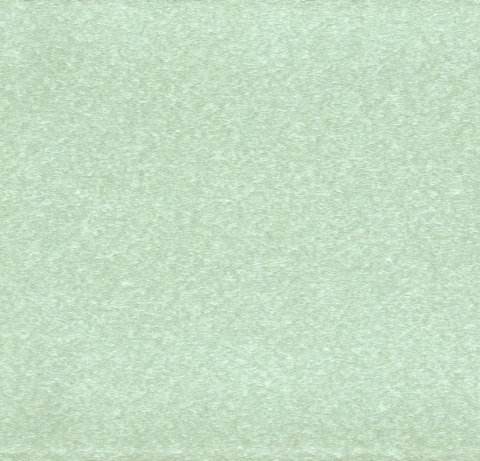 Close-up of a pale green textured surface with a subtle speckled pattern