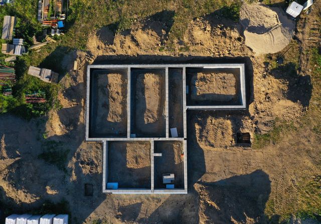 An aerial view of a house being built in the dirt