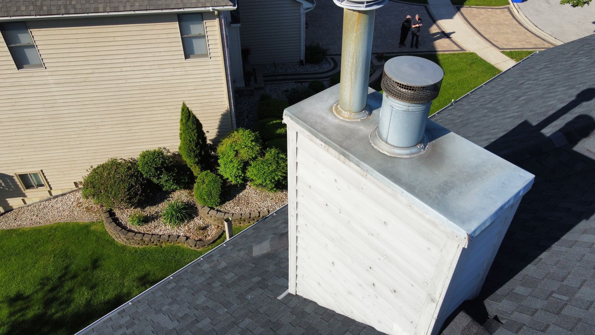 An aerial view of a chimney on the roof of a house.