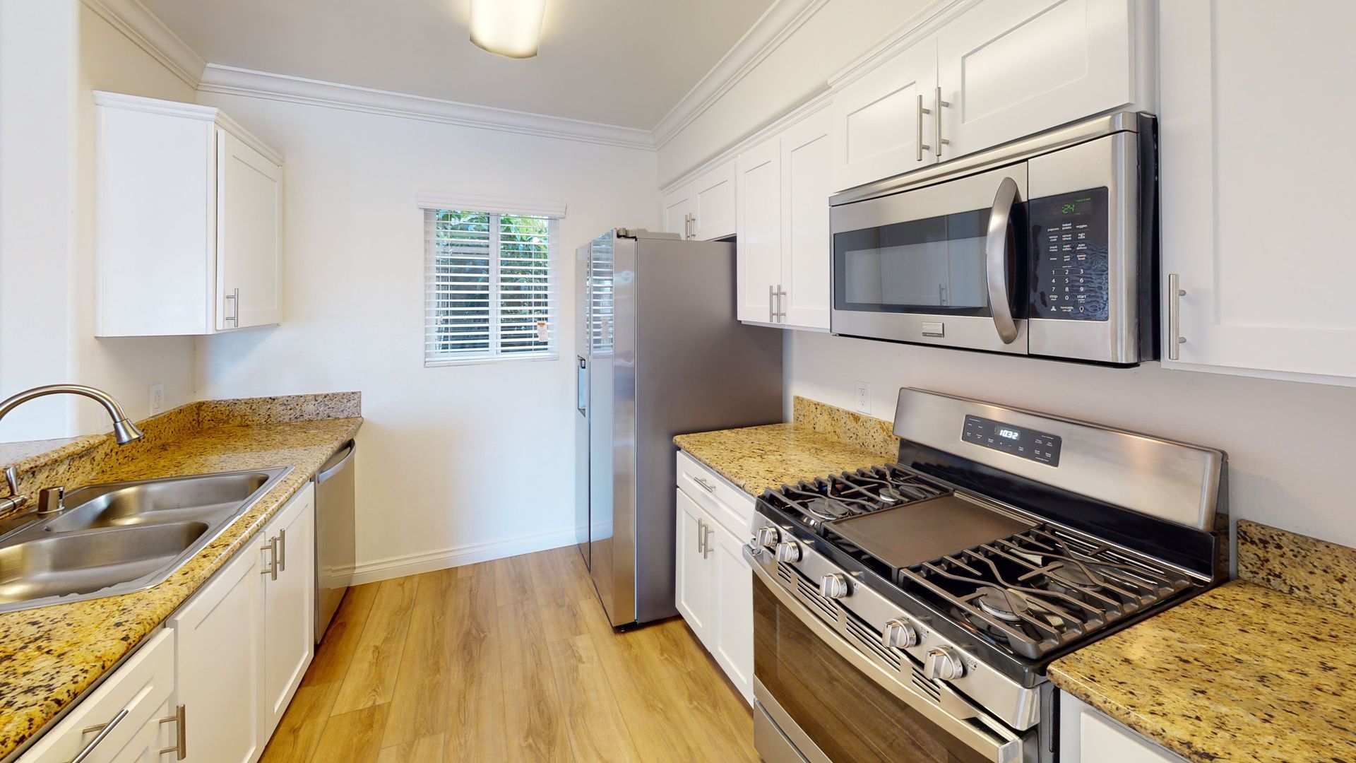 Kitchen with white cabinets, stainless steel appliances, and granite countertops.