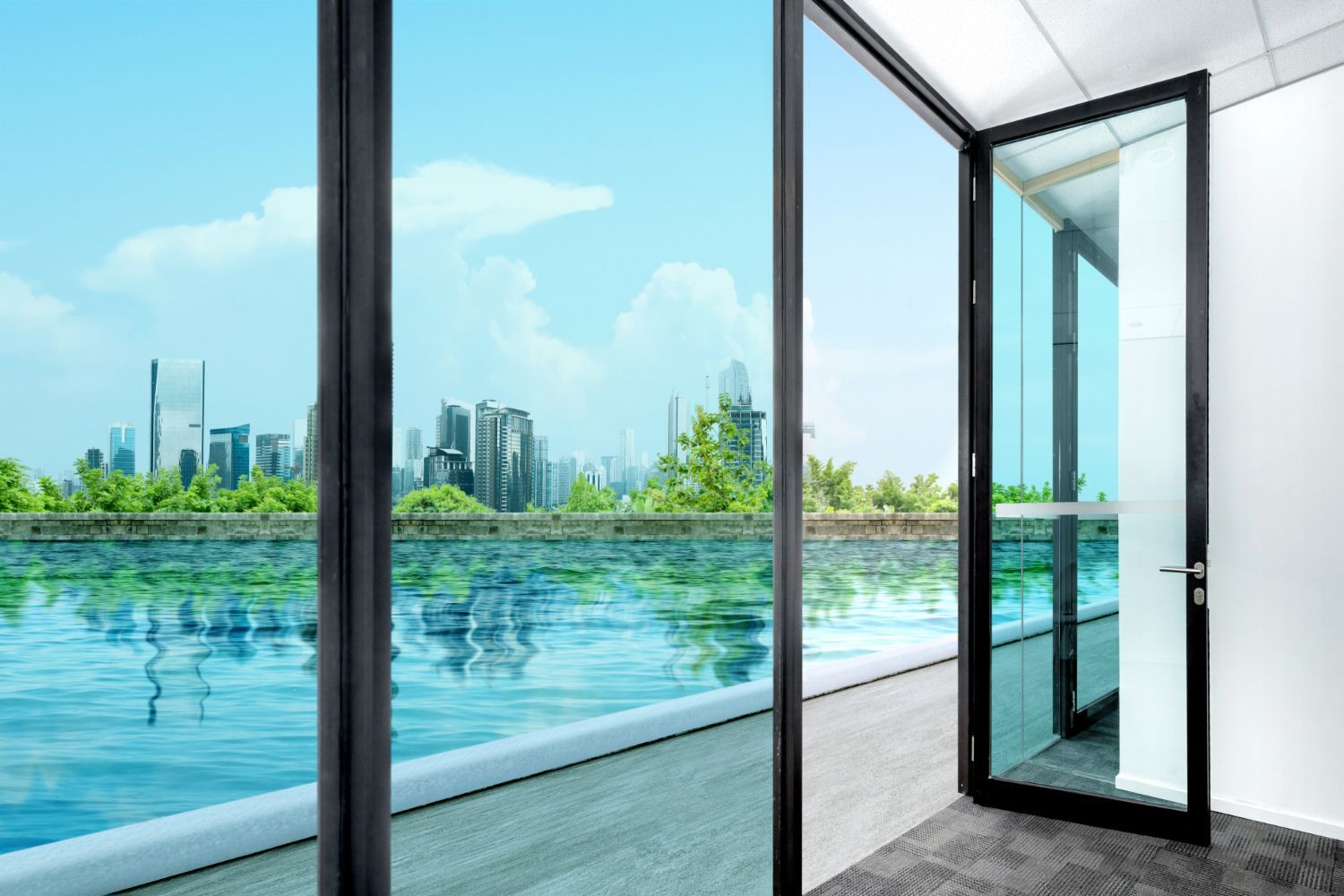 Open glass door overlooking a bright waterfront balcony and distant city skyline