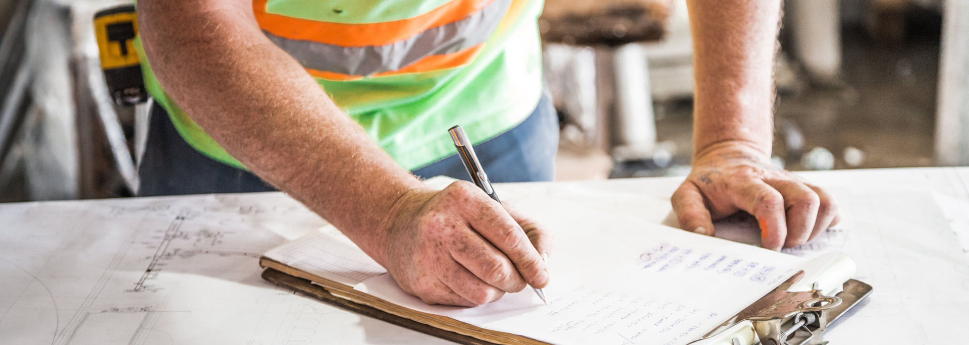 Picture of a construction worker writing. 