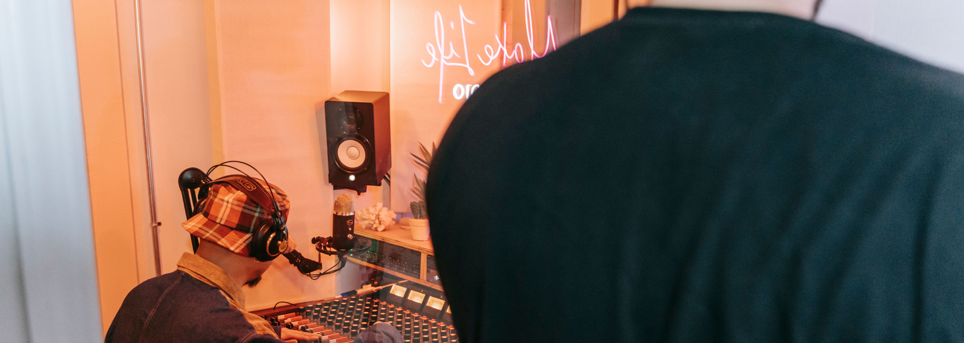 Picture of someone in a recording booth.