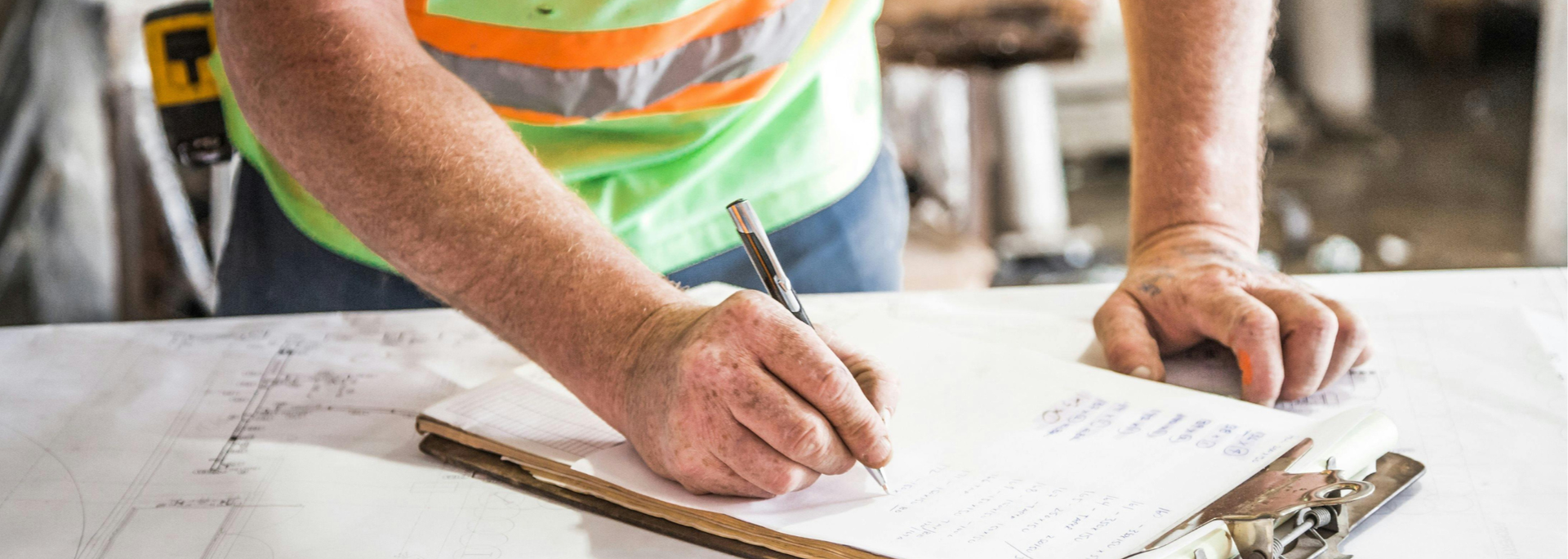 Picture of a builder writing. 