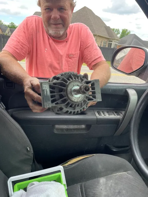 Mechanic servicing a diesel engine compartment