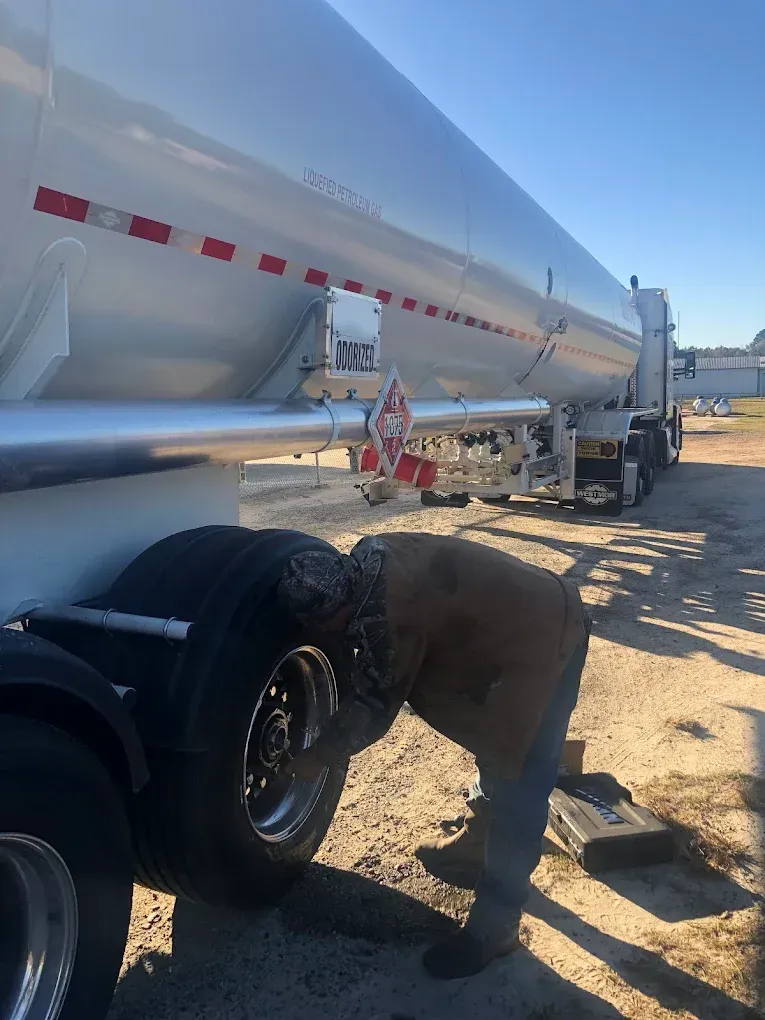 Mobile mechanic working on a semi-truck at the roadside