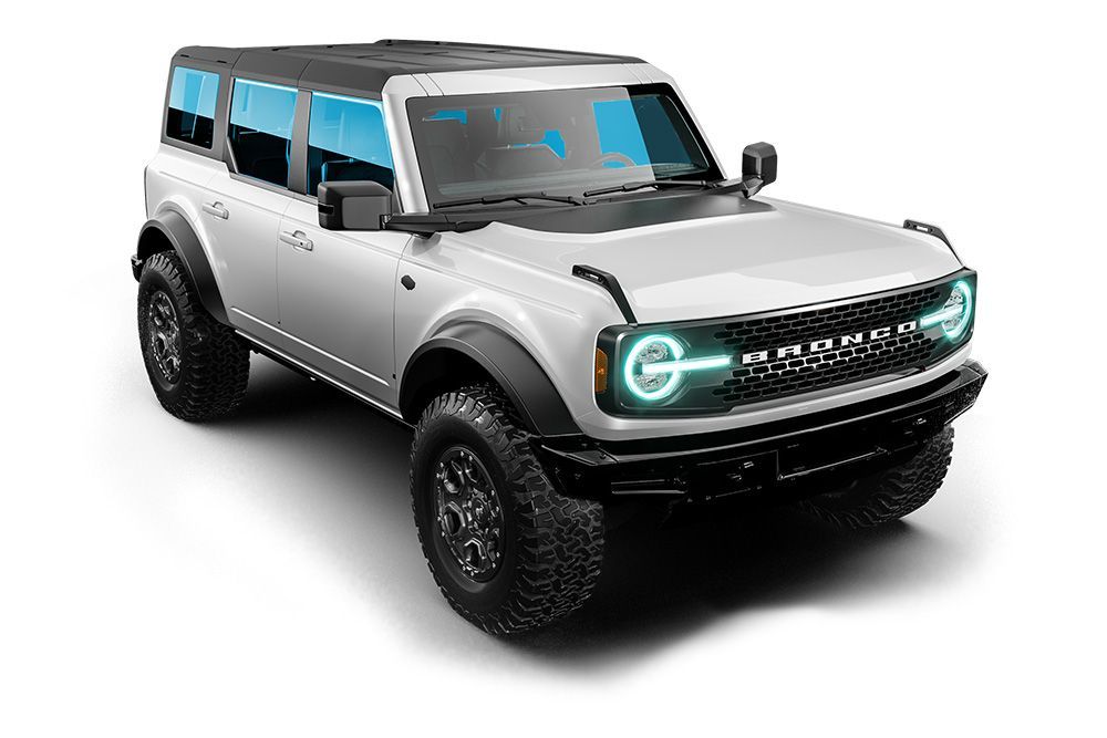 Silver off-road SUV with black trim and blue-tinted windows on a white background