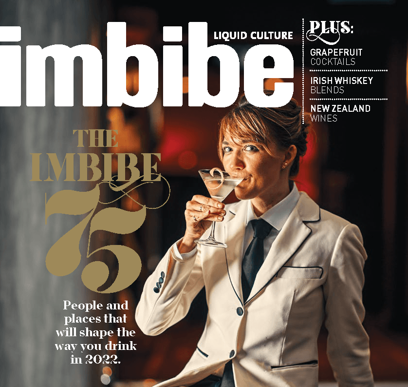 A woman is drinking a martini on the cover of imbibe magazine