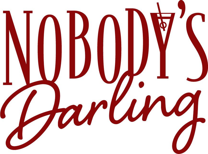 The word nobody 's darling is written in red on a white background.