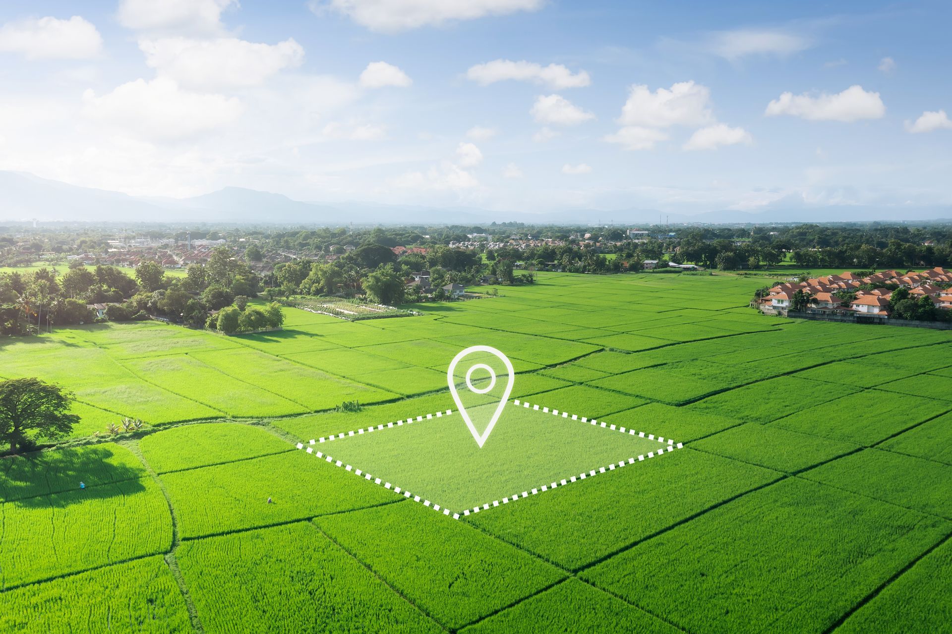 A land plot in aerial view with a registration symbol. A land plot in aerial view with a registration symbol.