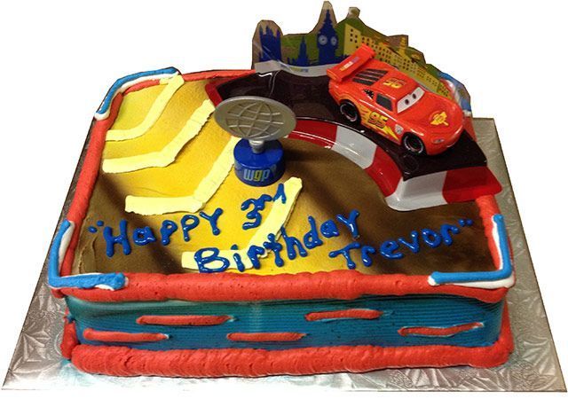 Birthday cake decorated with a red race car and the words “Happy Birthday Trevor”