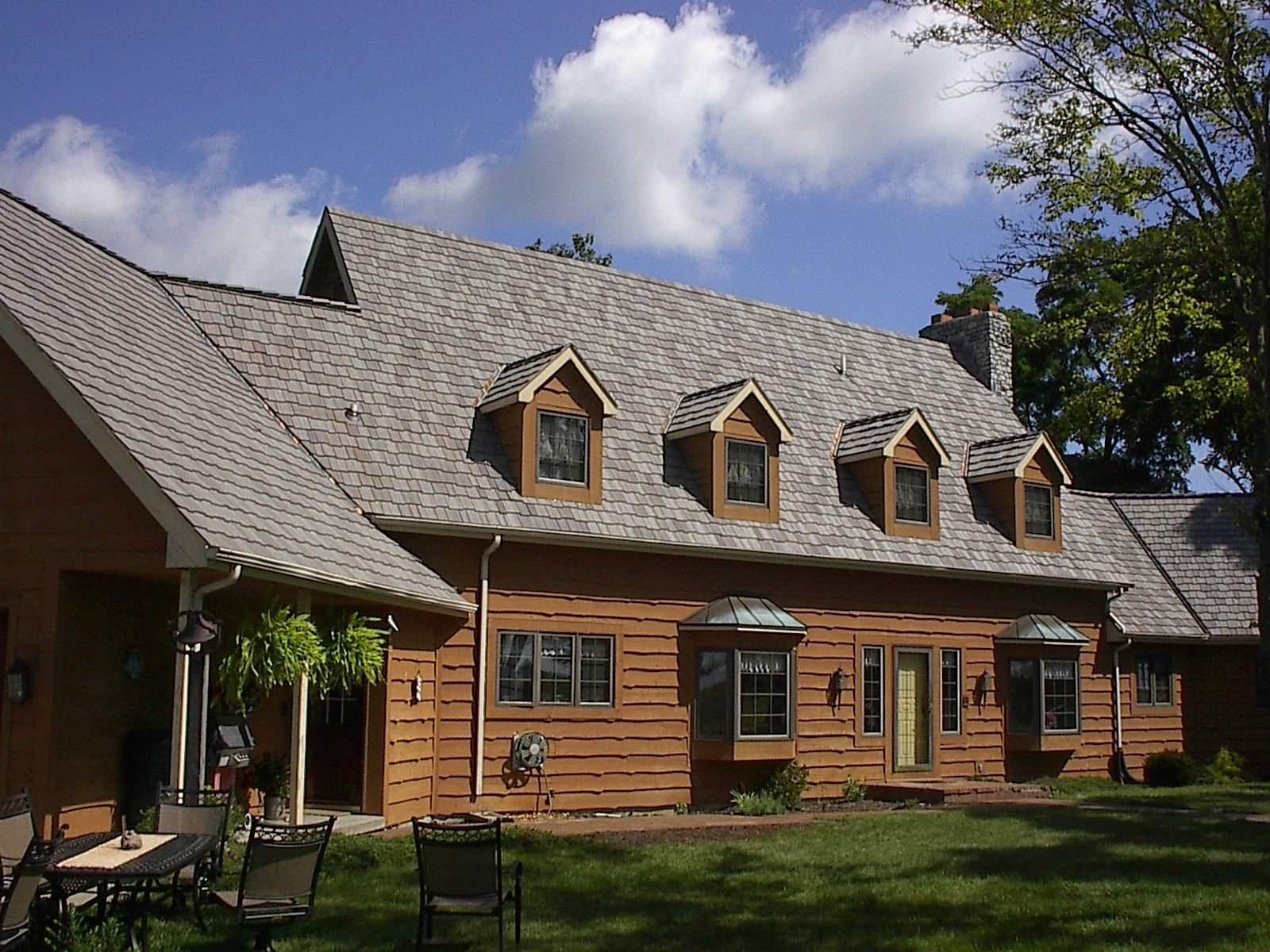 A large house with a lot of windows and a gray roof