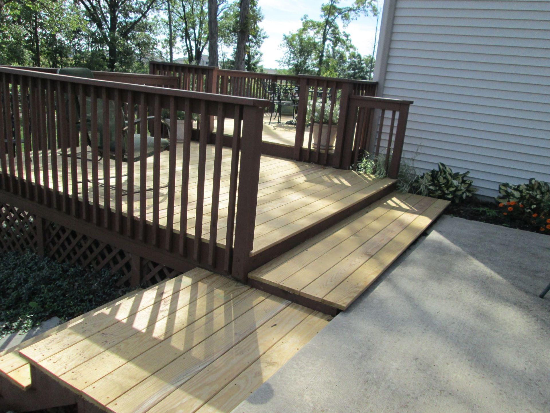A wooden deck with stairs leading up to it