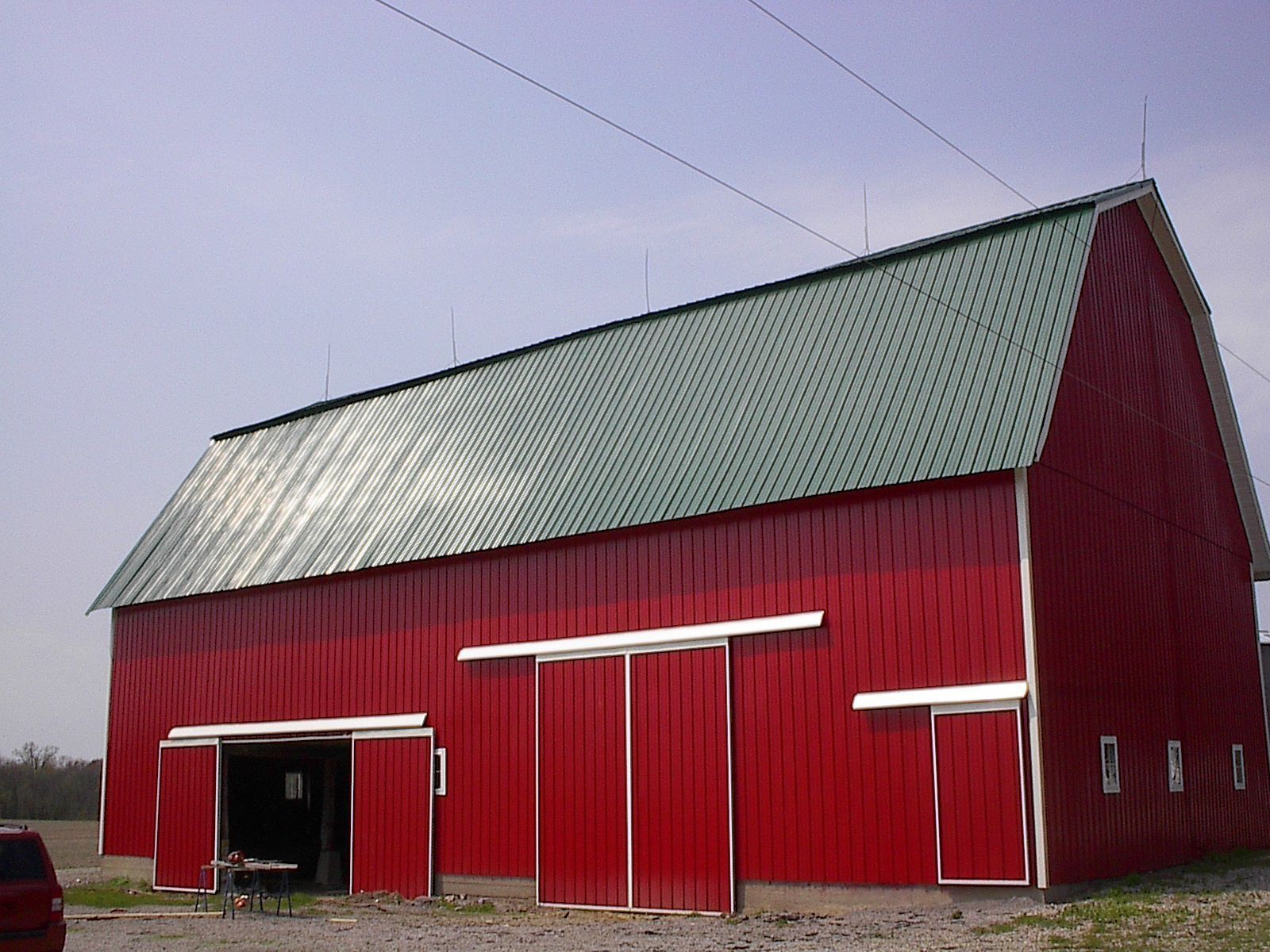 A red barn with a green roof and white trim