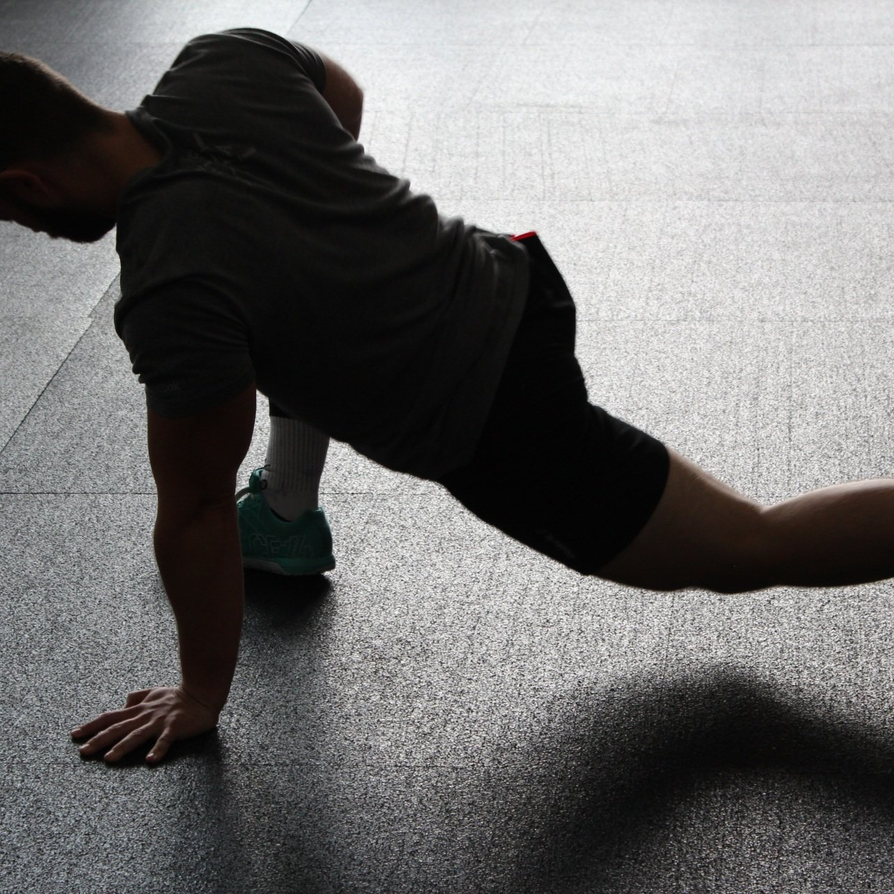 Man stretching his body on the floor