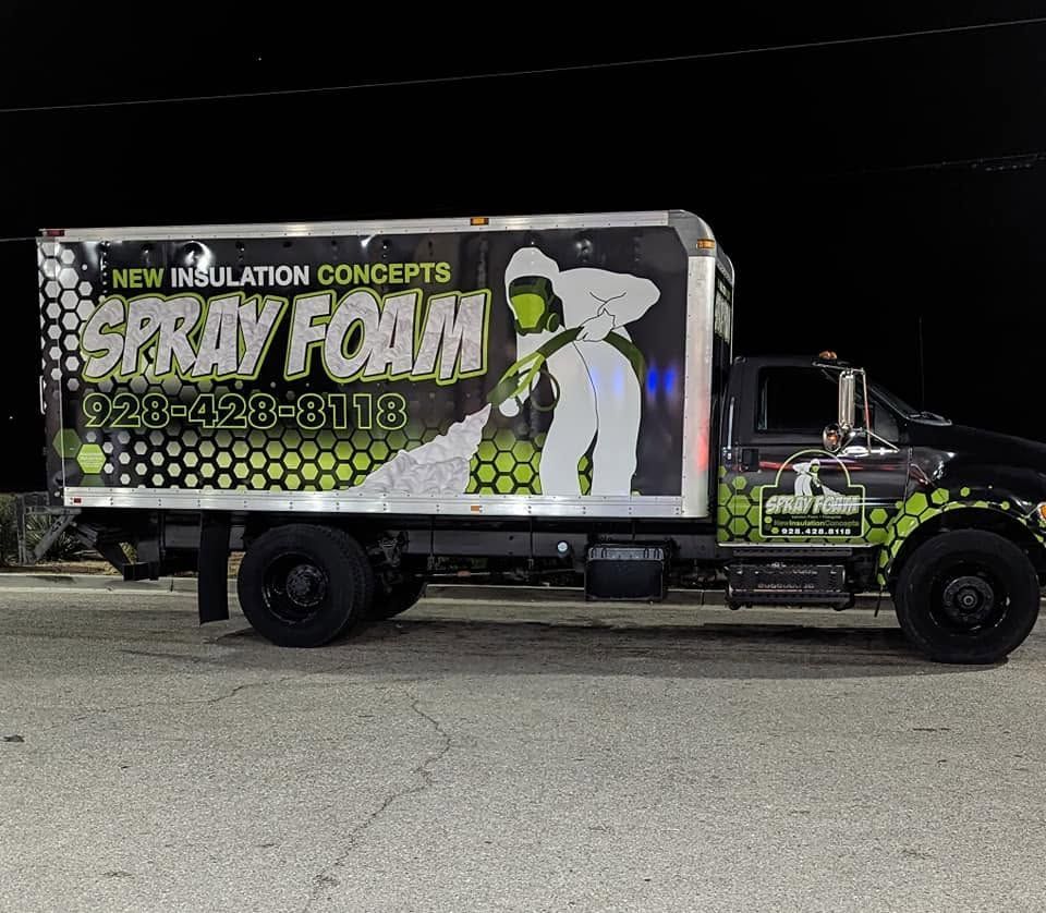Customized insulation truck with bold graphics and green lettering parked at night