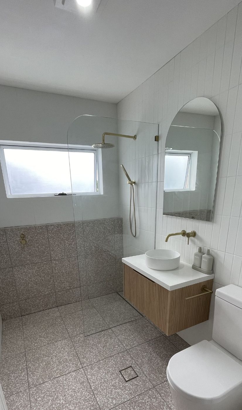 A Bathroom With a Sink, Mirror, Shower and Faucet — Bathurst Bathroom Solutions In Eglinton, NSW