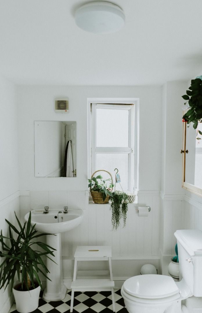 A Bathroom With a Toilet, Sink, and Mirror — Bathurst Bathroom Solutions In Eglinton, NSW