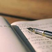 Fountain pen resting on handwritten notes in an open notebook