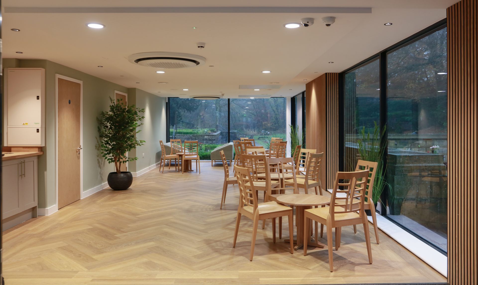 A large room with tables and chairs in it.
