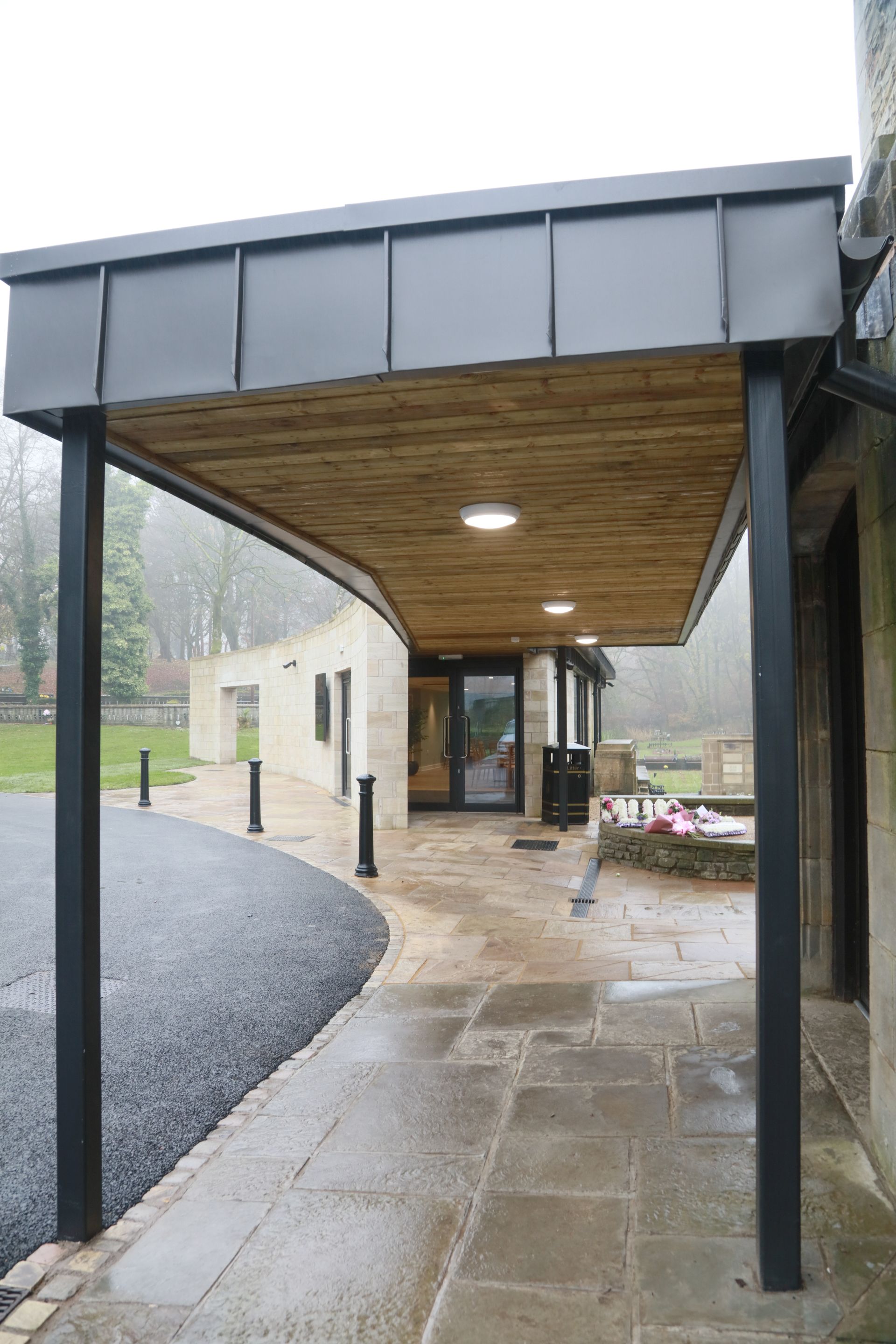 A walkway leading to a building with a canopy over it.