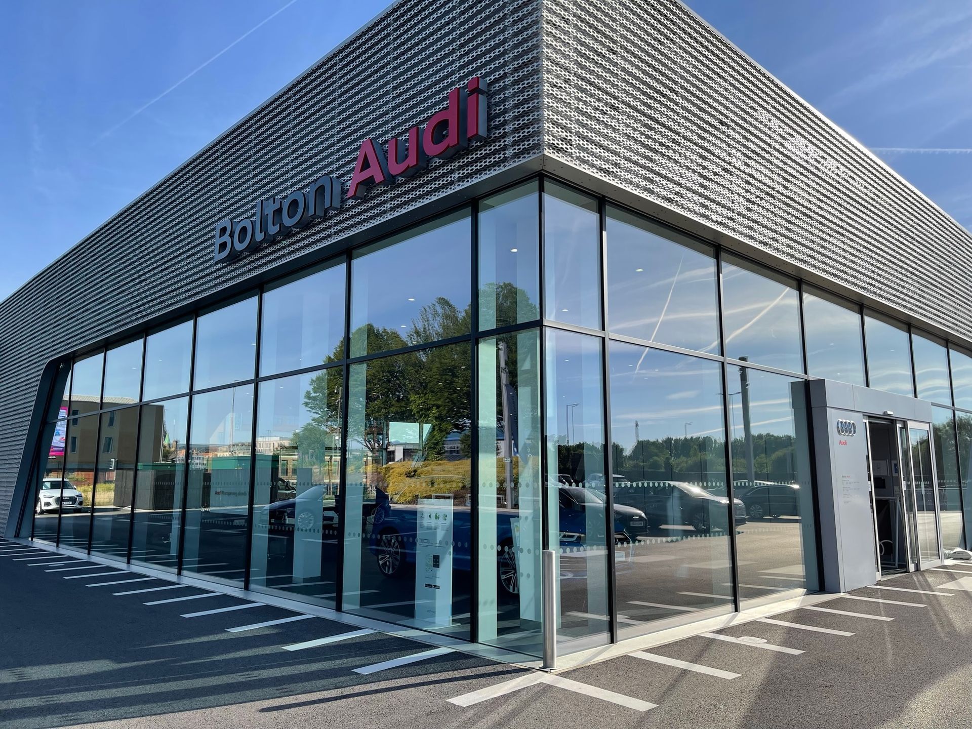 A large glass building with the word audi on it.