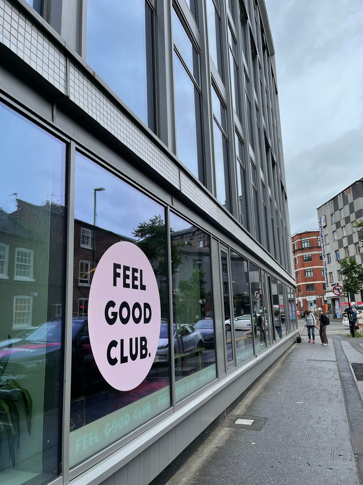A building with a sign on the side that says feel good club
