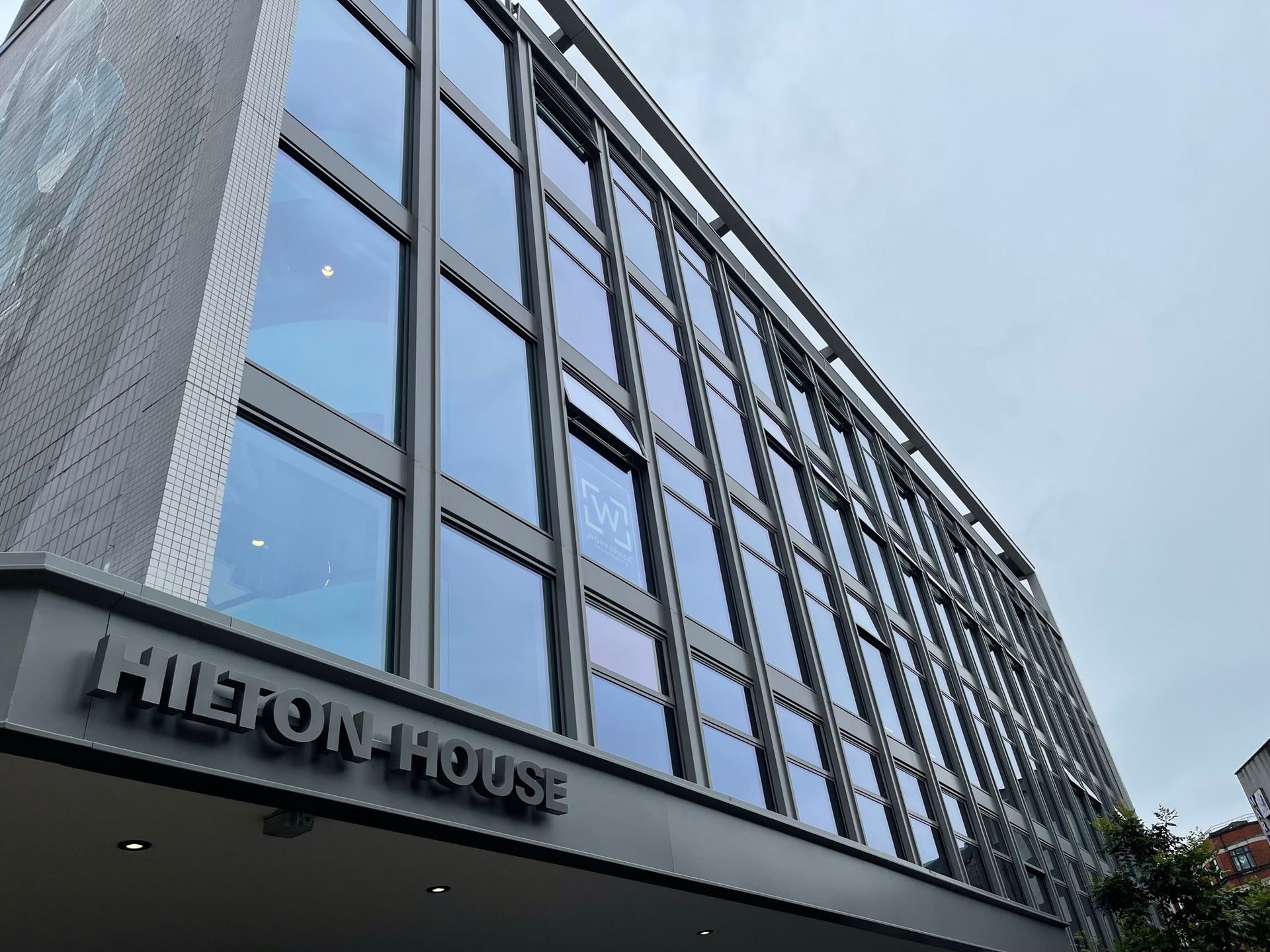 A large building with a lot of windows and the word hilton house on it.