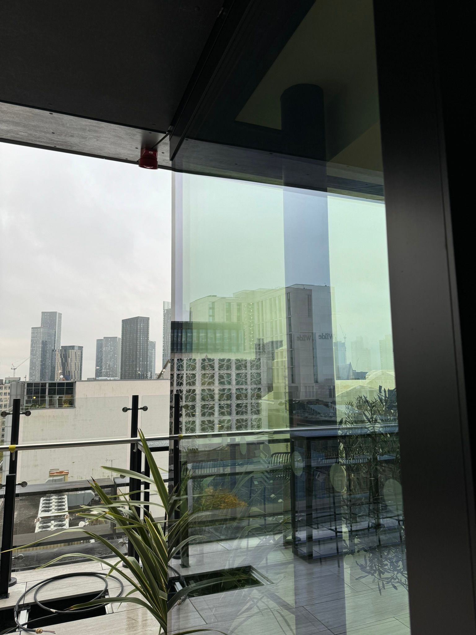 A balcony with a view of a city skyline.