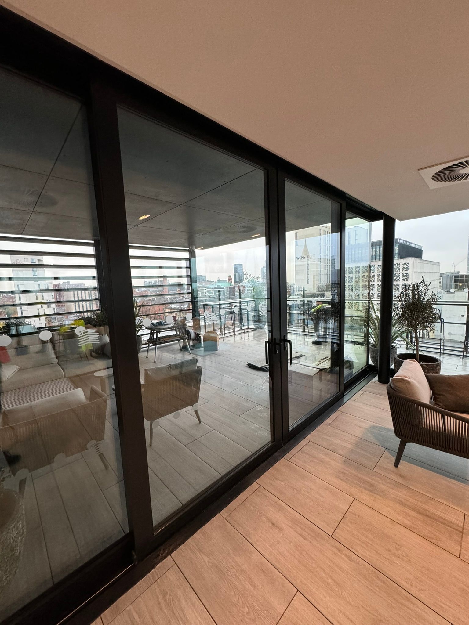 A living room with a lot of windows and a balcony.