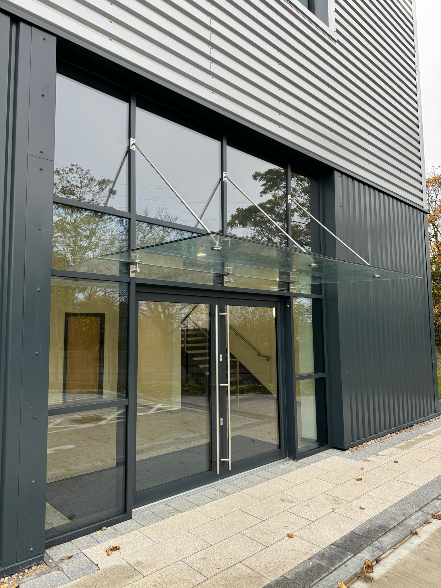 A large building with a glass canopy over the entrance.