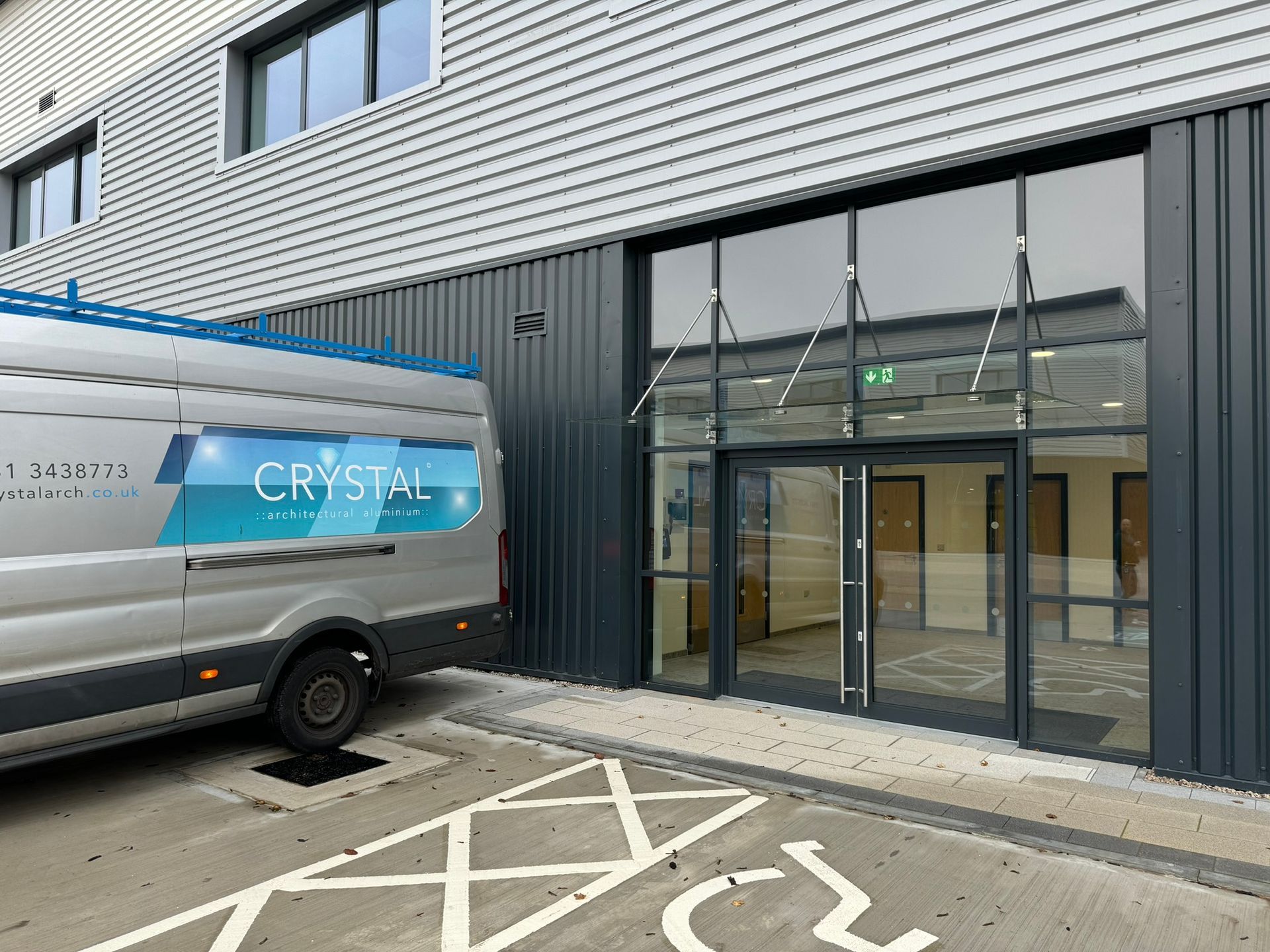 A van is parked in front of a building.