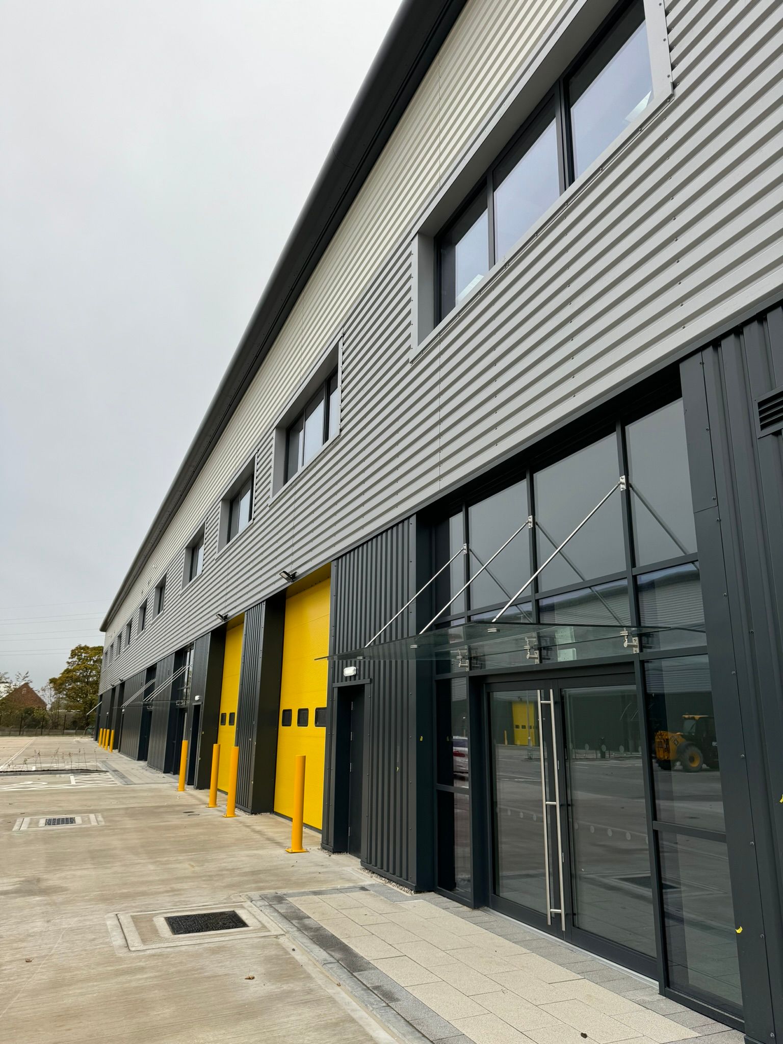 A large building with a lot of windows and yellow doors.
