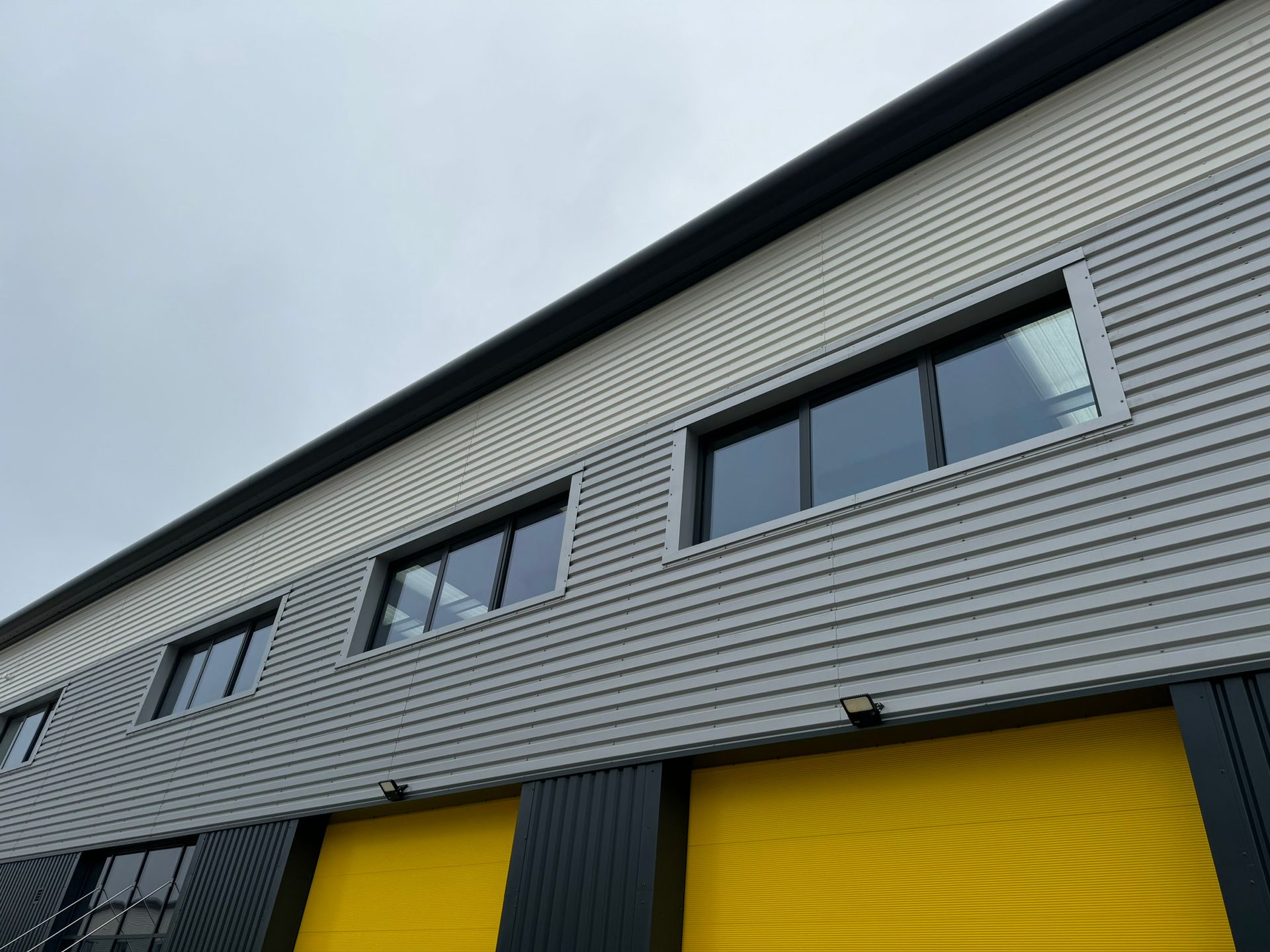 A building with a lot of windows and yellow doors
