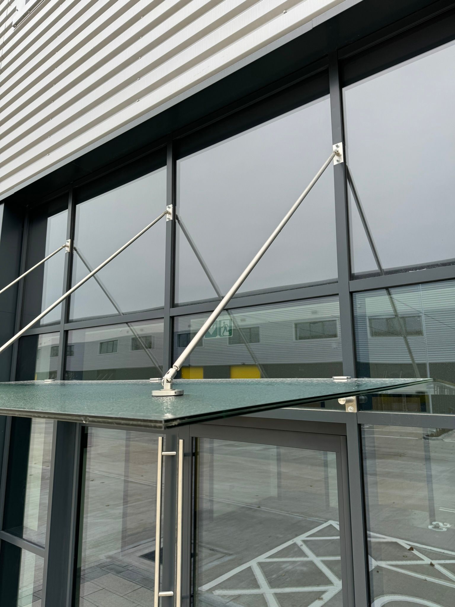 A building with a glass canopy over a door.