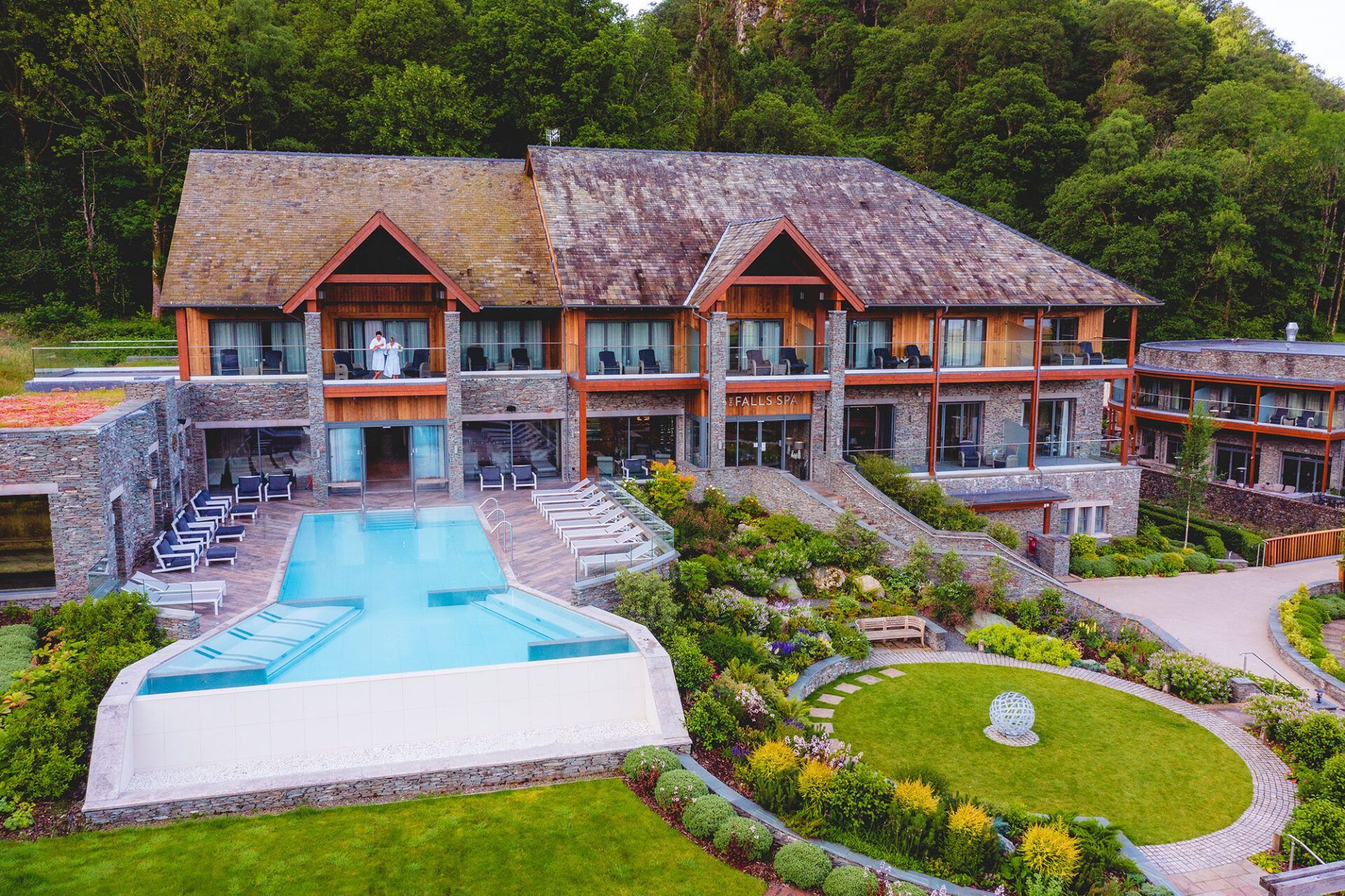A large house with a large swimming pool in front of it