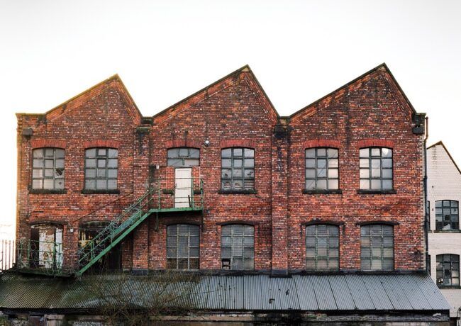 A brick building with a green fire escape on the side