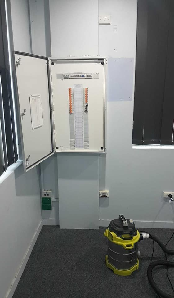 A Gloved Hand Flips a Circuit Breaker Switch in an Electrical Panel — Ionspark Electrical in Atherton, QLD