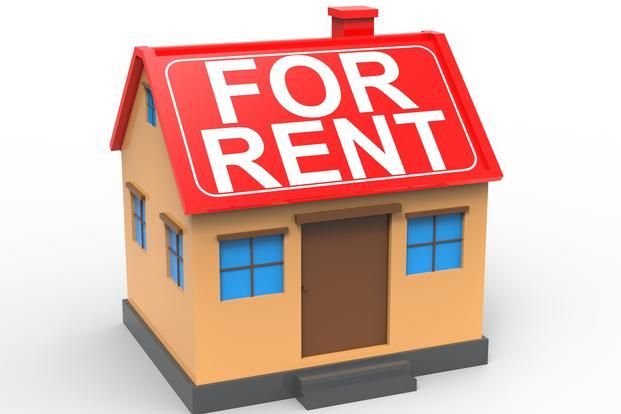 A small house with a for rent sign on the roof