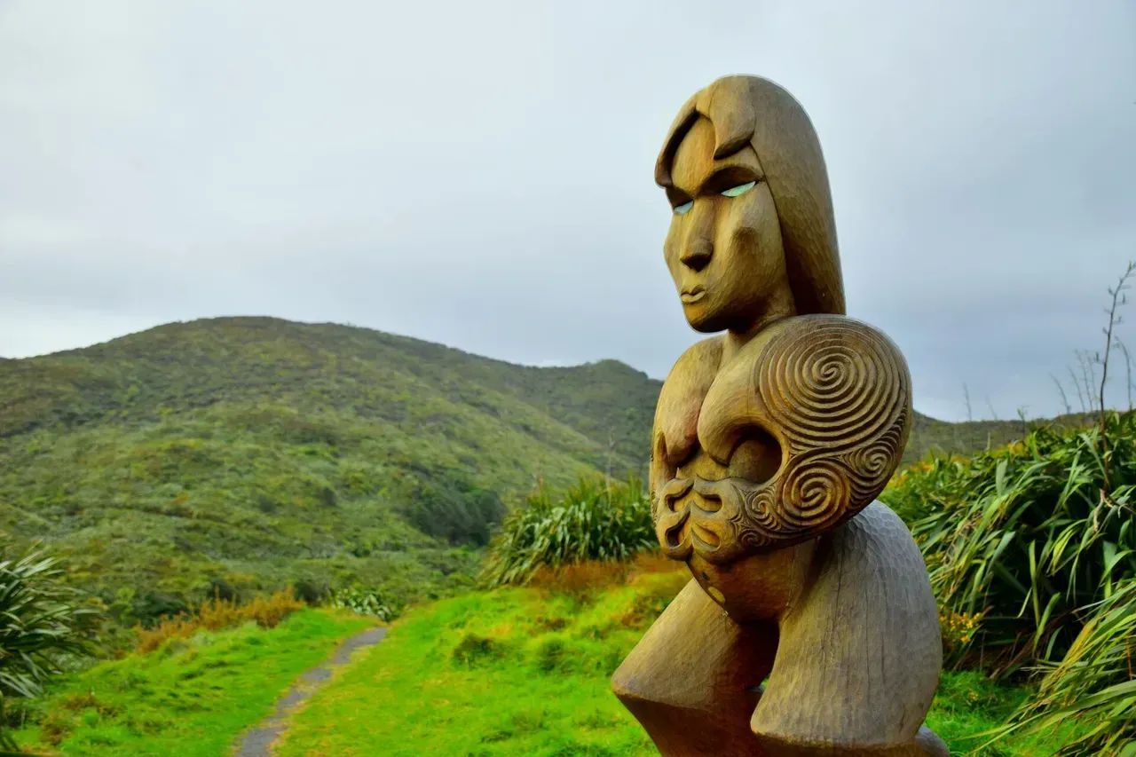 A maori carving set in a new Zealand landscape