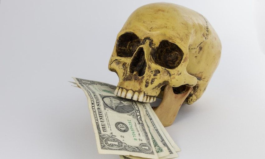 A skull with a dollar bill in its mouth.