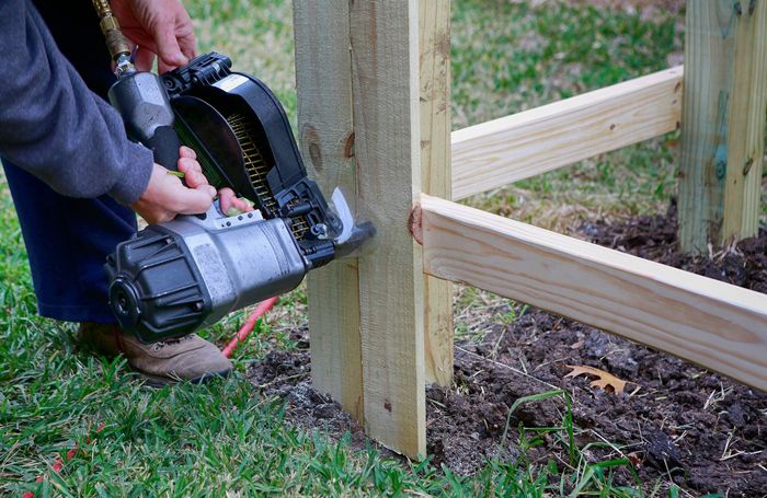 Attach wood pickets to the rail for new fence