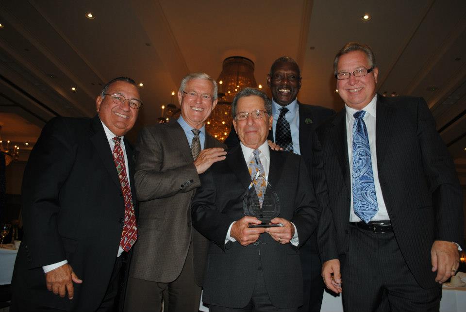 A group of men in suits and ties posing for a picture